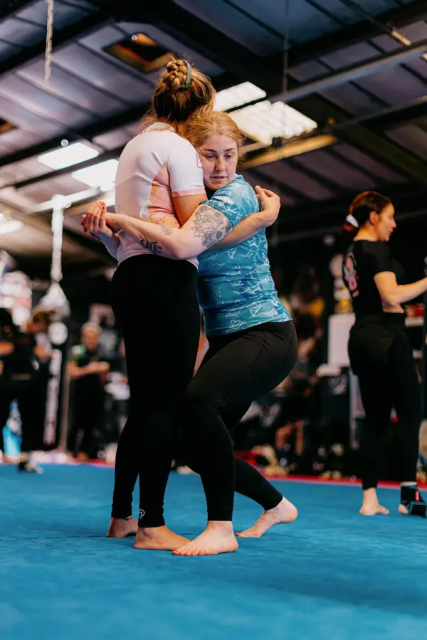 Two women in a wrestling tie-up