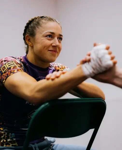 Katrina Fisher smiling while her hands are wrapped before a fight